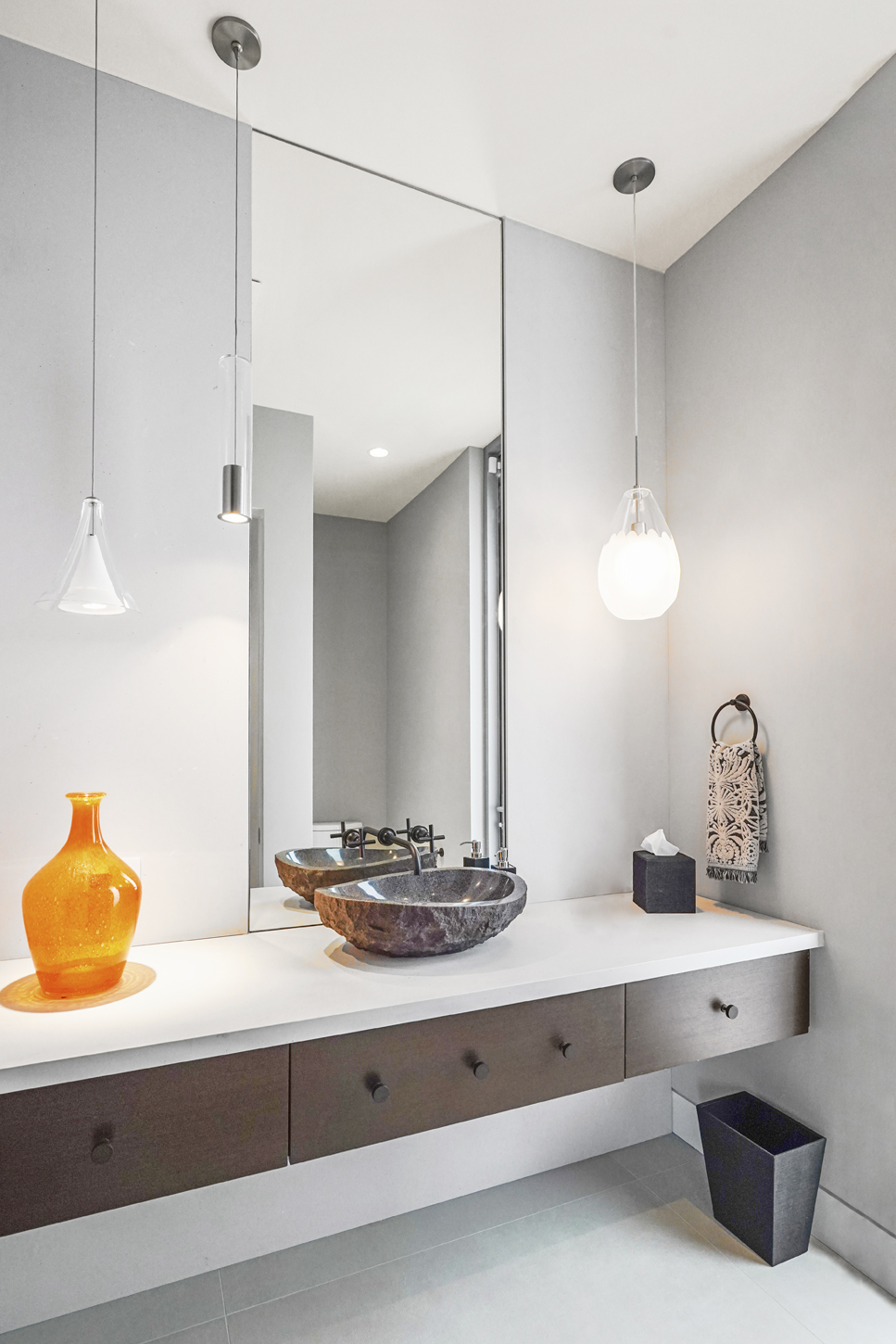Powder room with sculptural vessel sink and floating vanity