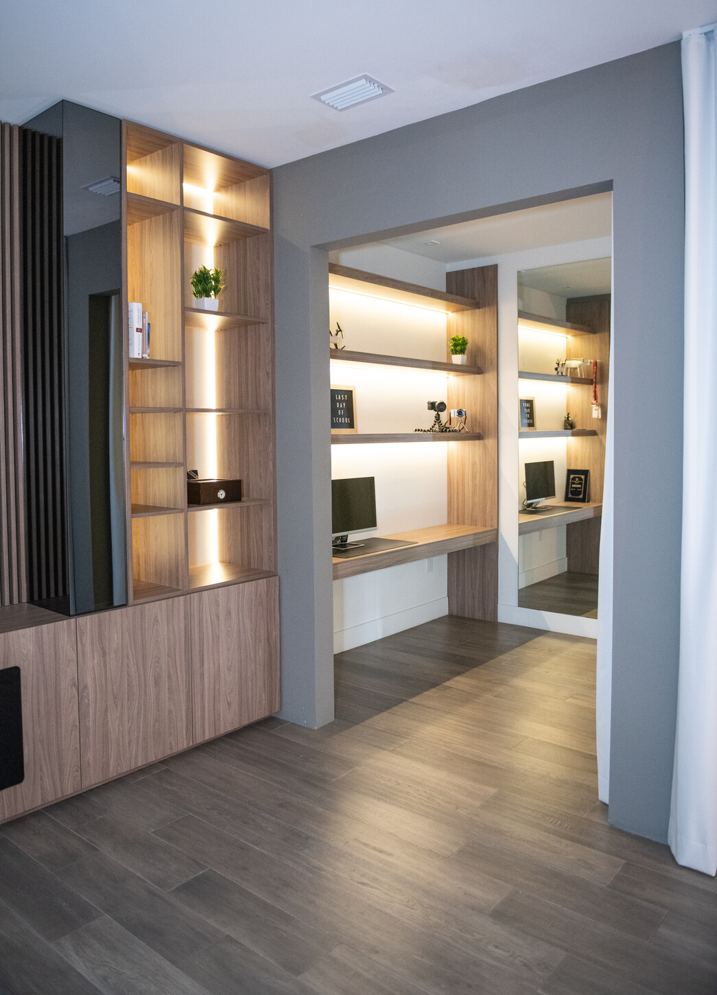 Master bedroom feature wall with integrated TV wall unit and headboard designed as one elevation in Weston Botanico residence