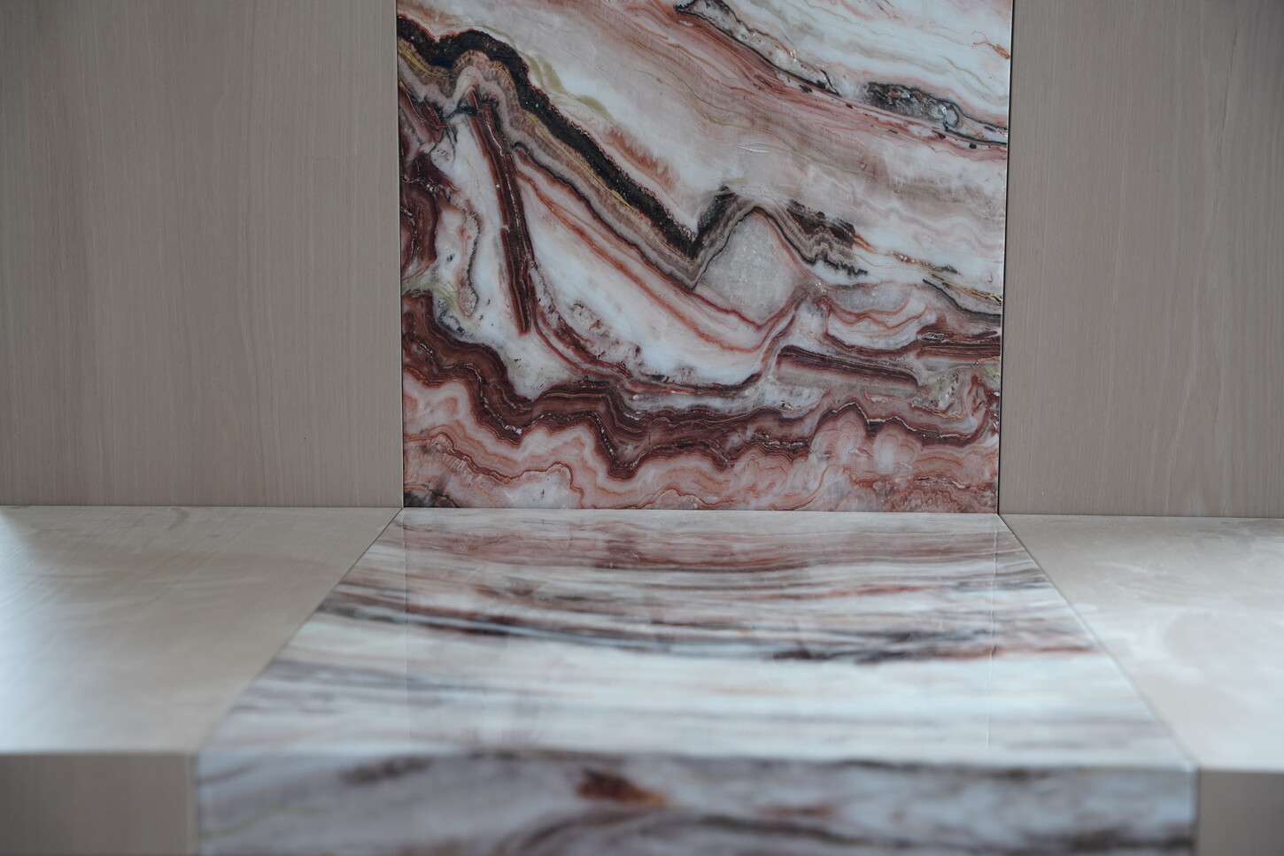 Bookmatched imitation stone wall panel and console detail with high-gloss epoxy finish