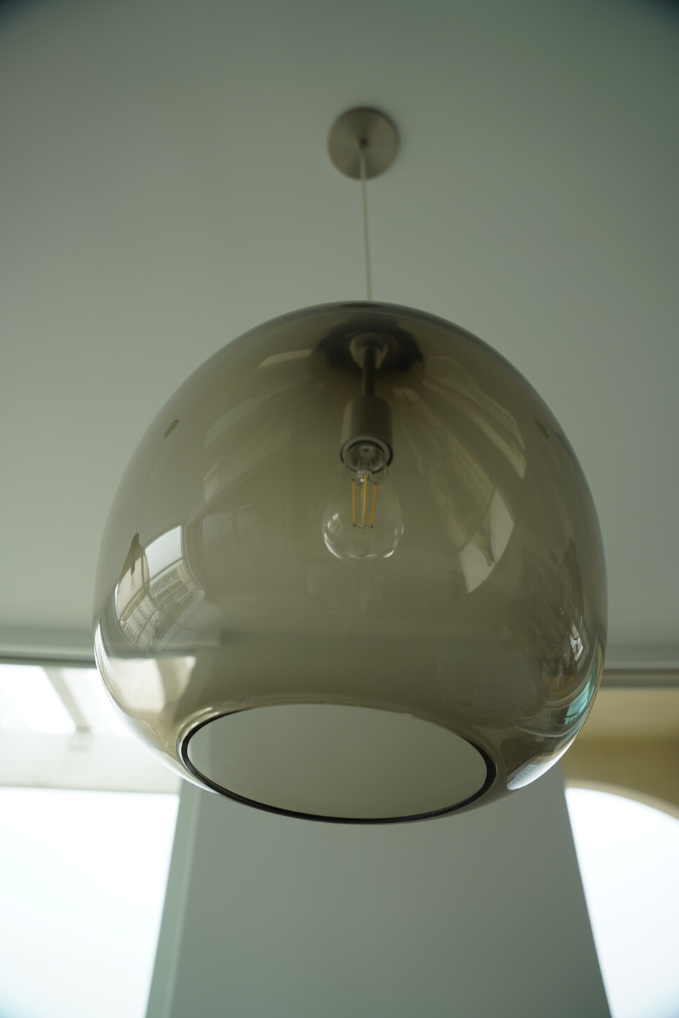 Smoked glass globe pendant light fixture in a Boca Raton interior