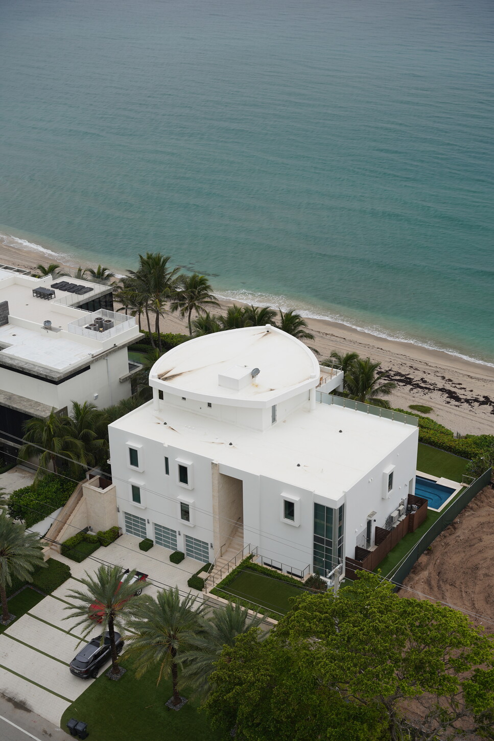 Aerial view of a modern oceanfront Boca Raton home with a rooftop pool terrace