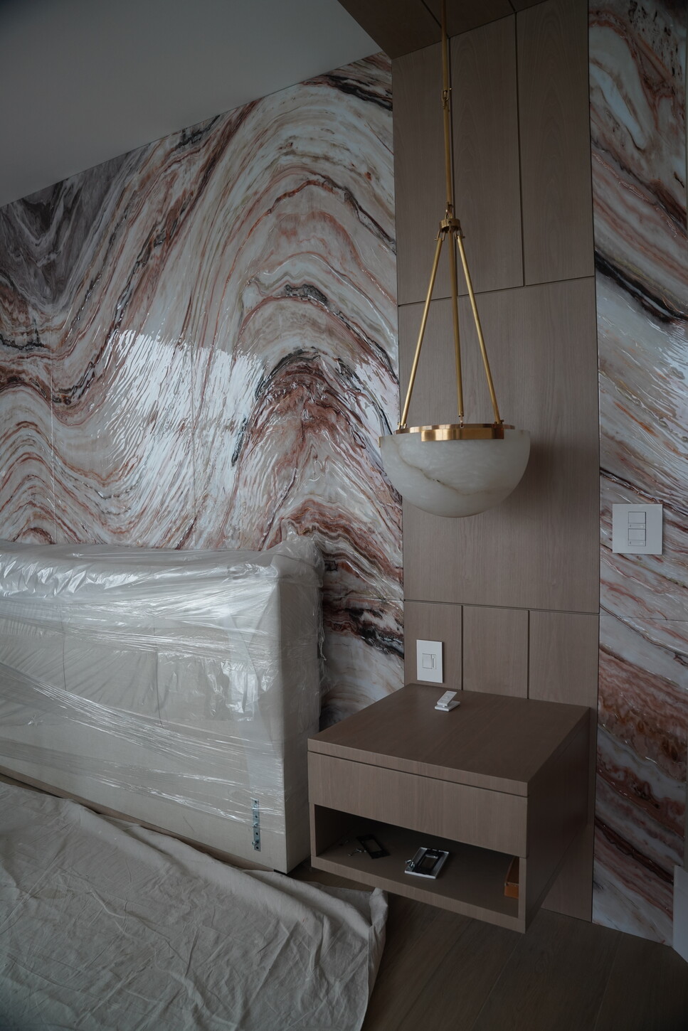 Custom headboard feature wall with a floating nightstand in a master bedroom renovation
