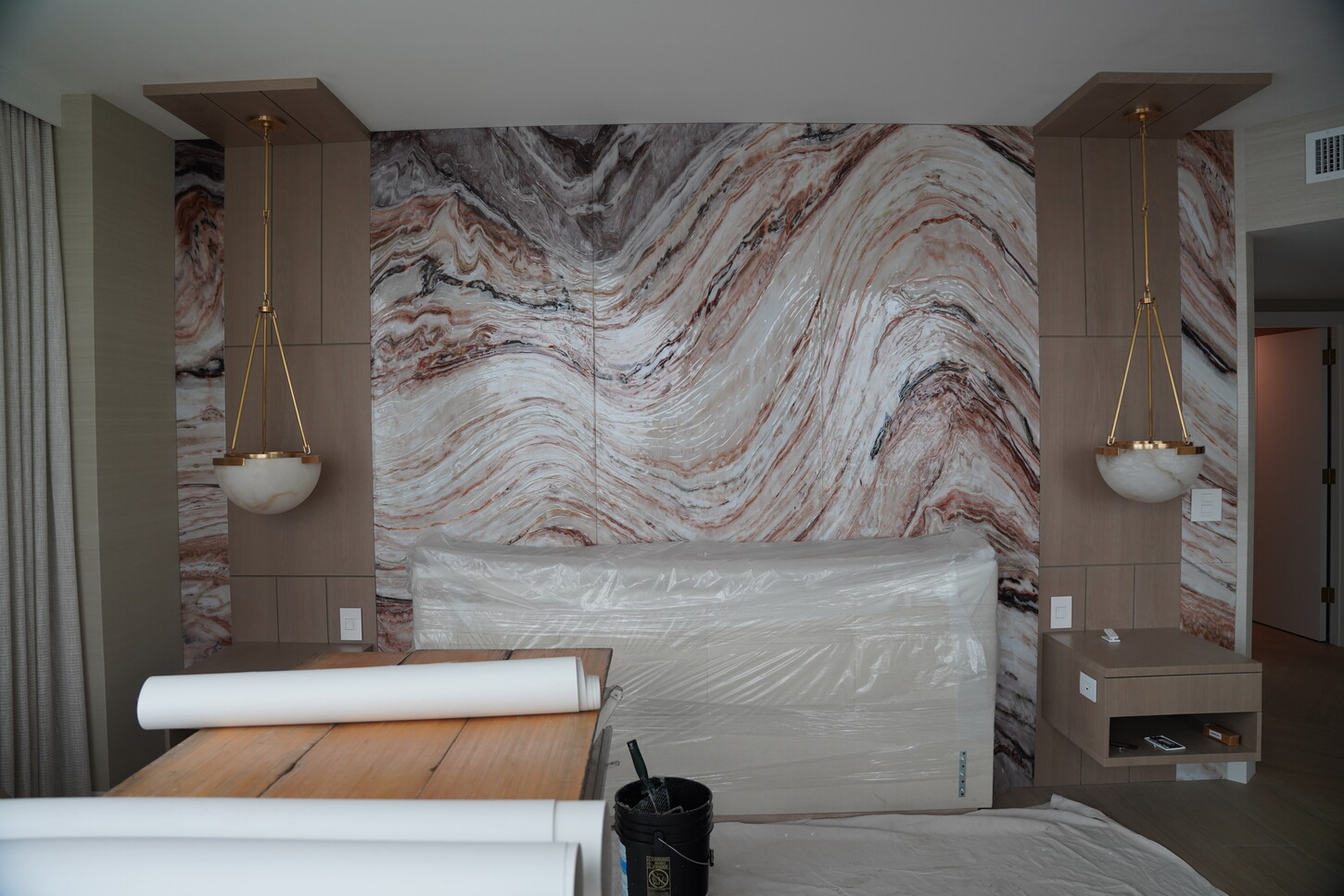 Ultra-style headboard feature wall with paired pendant niches in a luxury master bedroom