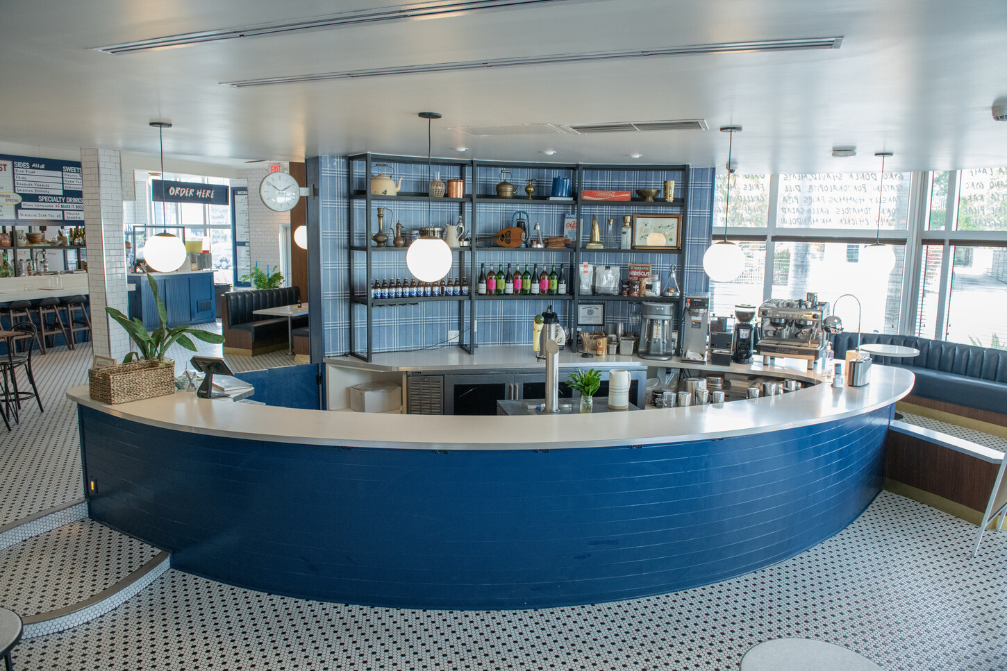Wide view of curved bar back shelving with bottle display