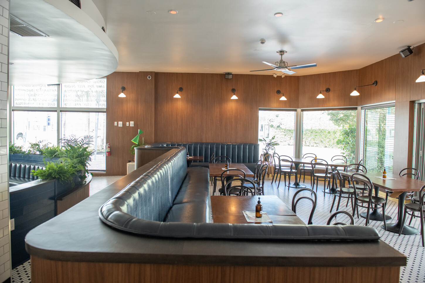 Curved navy banquette seating with a daylight window view