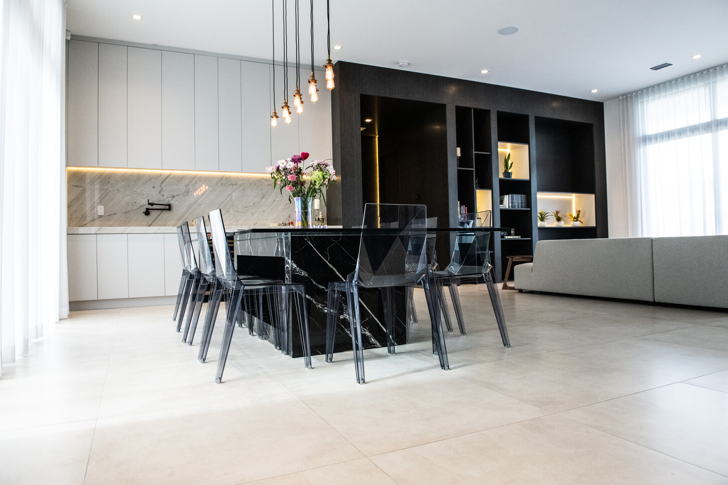 Custom bar unit with large-format dark wood cabinetry and gold accent lighting in Weston Botanico residence