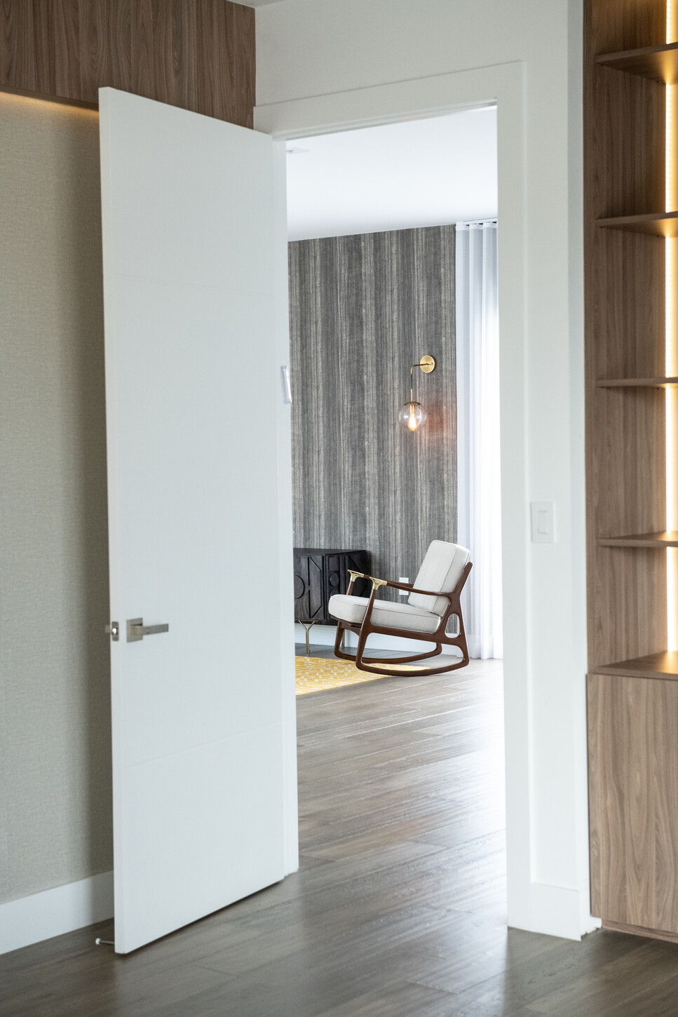 Custom wood shelving along a hallway leading to the primary bedroom in Weston Botanico residence
