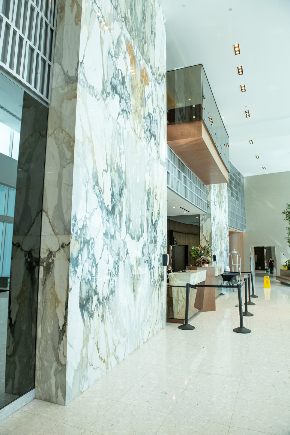 Marble columns framing the concierge desk in a Miami condo lobby