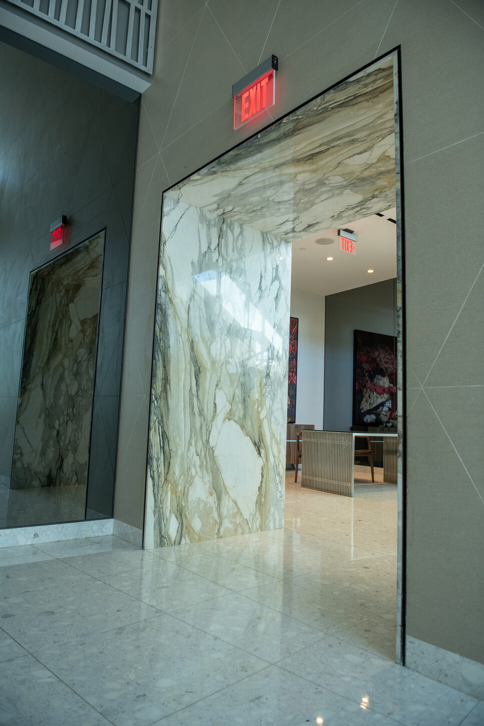 Marble-clad portal and exit in a Miami condo lobby