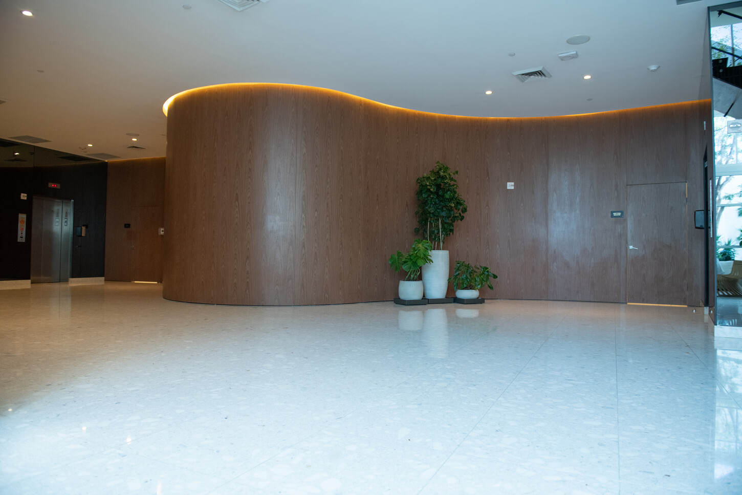 Wood-paneled seating area in a Miami condo lobby lounge