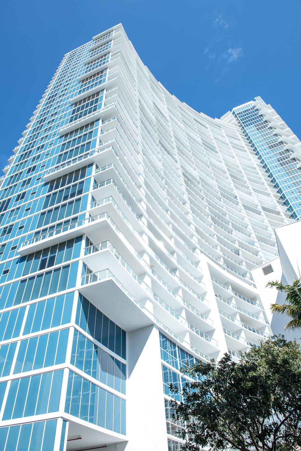 Glass balcony facade detail on a Miami condo tower
