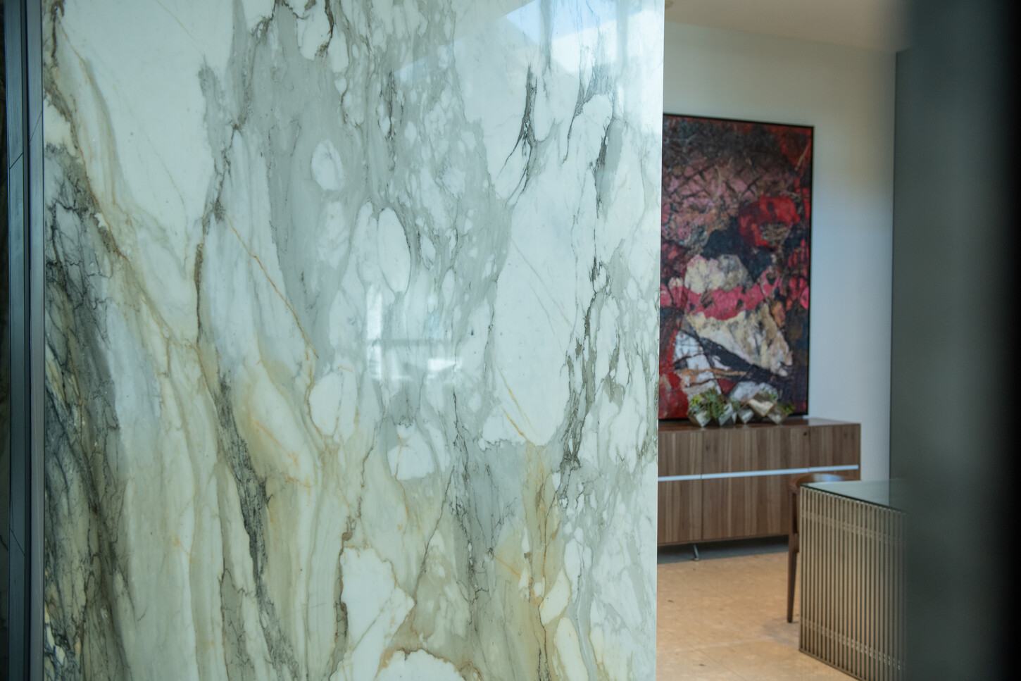 Book-matched marble slab accent wall in a Miami residential lobby
