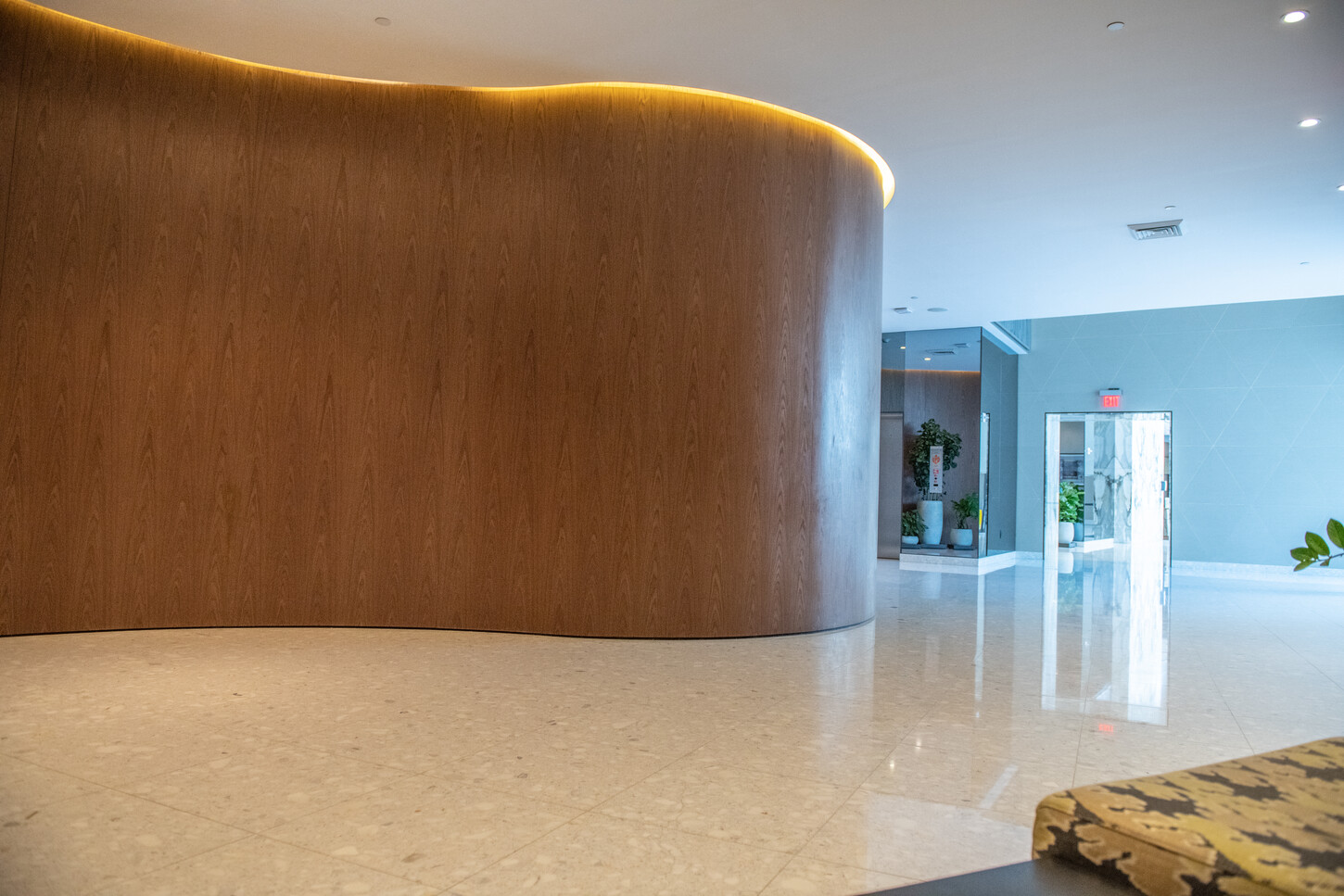 Custom wood paneling and marble flooring in a Miami residential lobby