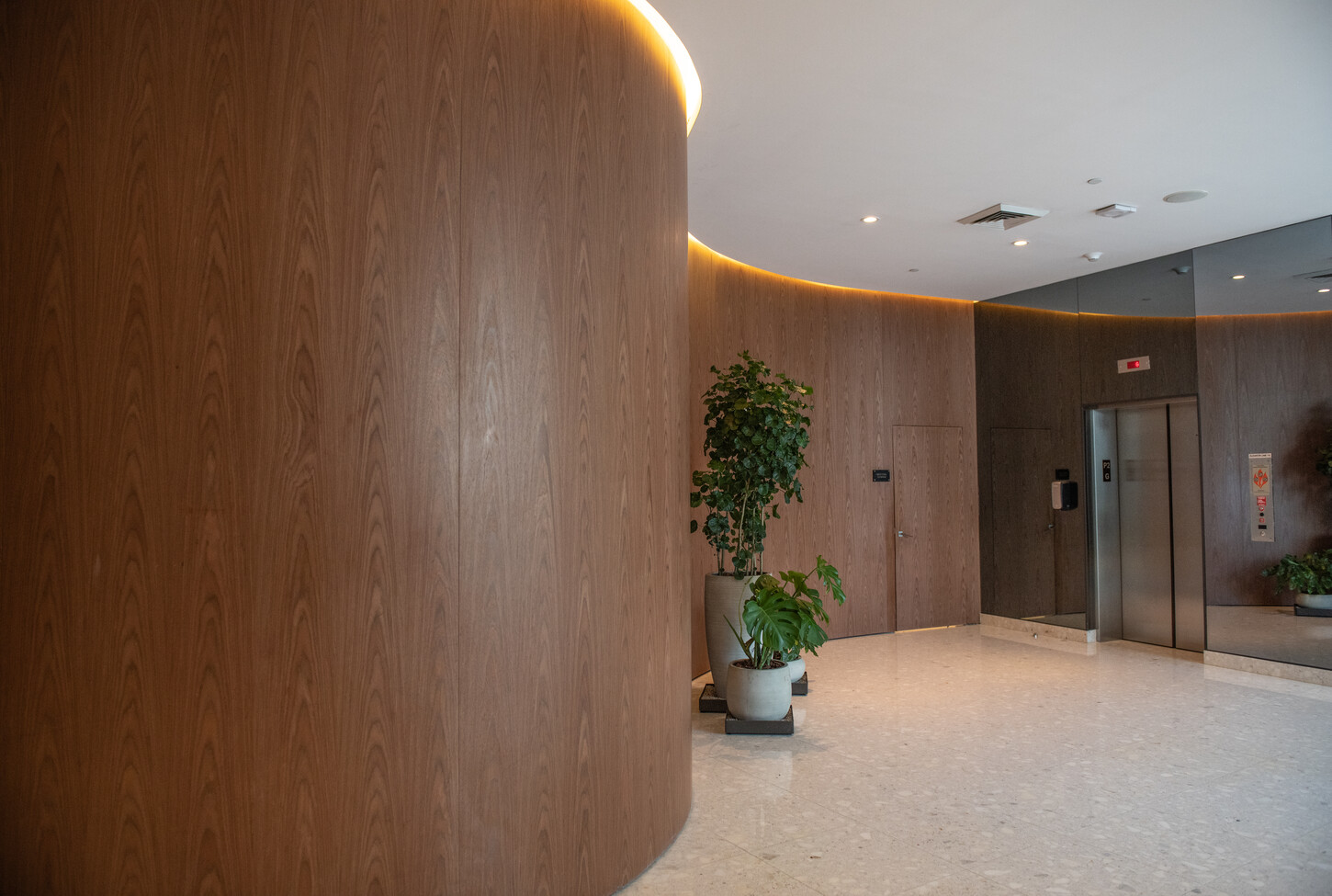 Custom wood wall near the elevator lounge in a Miami residential building