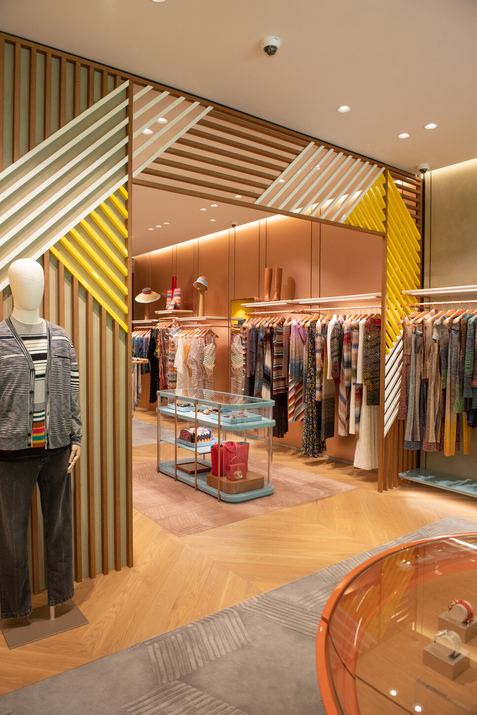Interior display fixtures and pendant lighting near the storefront window in the Missoni boutique