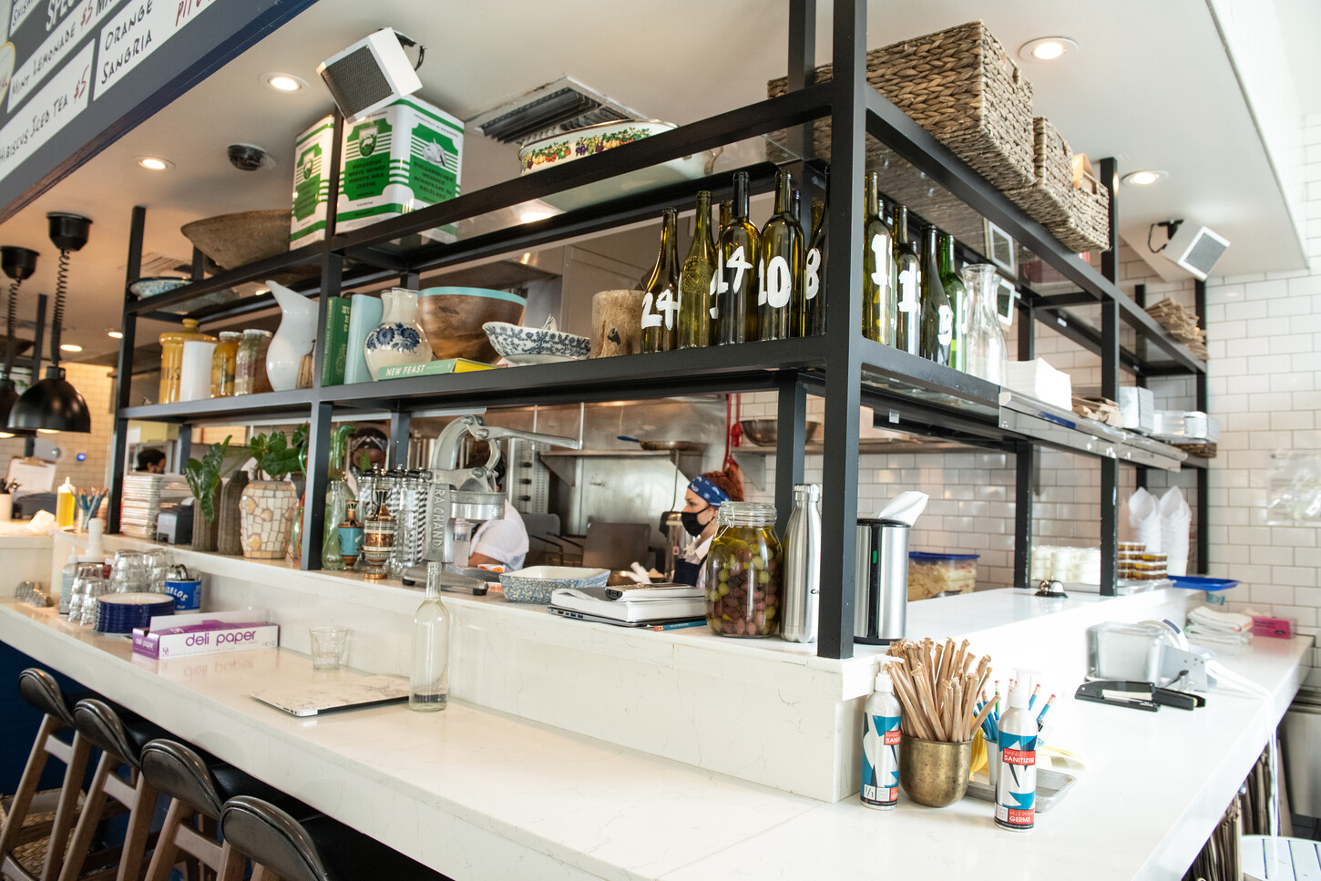 Open kitchen cooking station with hanging pendant lights