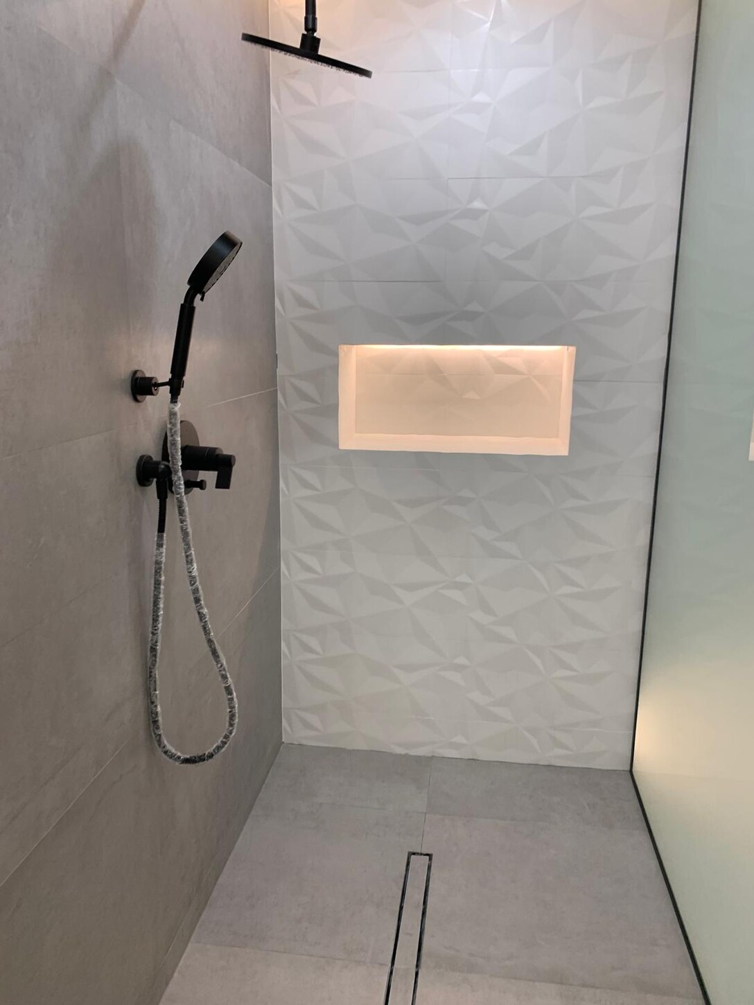 Angled hallway view with integrated LED cove lighting and marble flooring