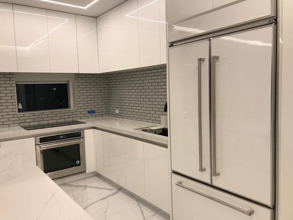 Kitchen backsplash and built-in wall oven at night