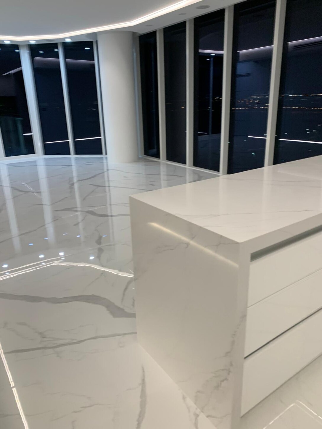 Kitchen cabinetry and wall oven detail at night