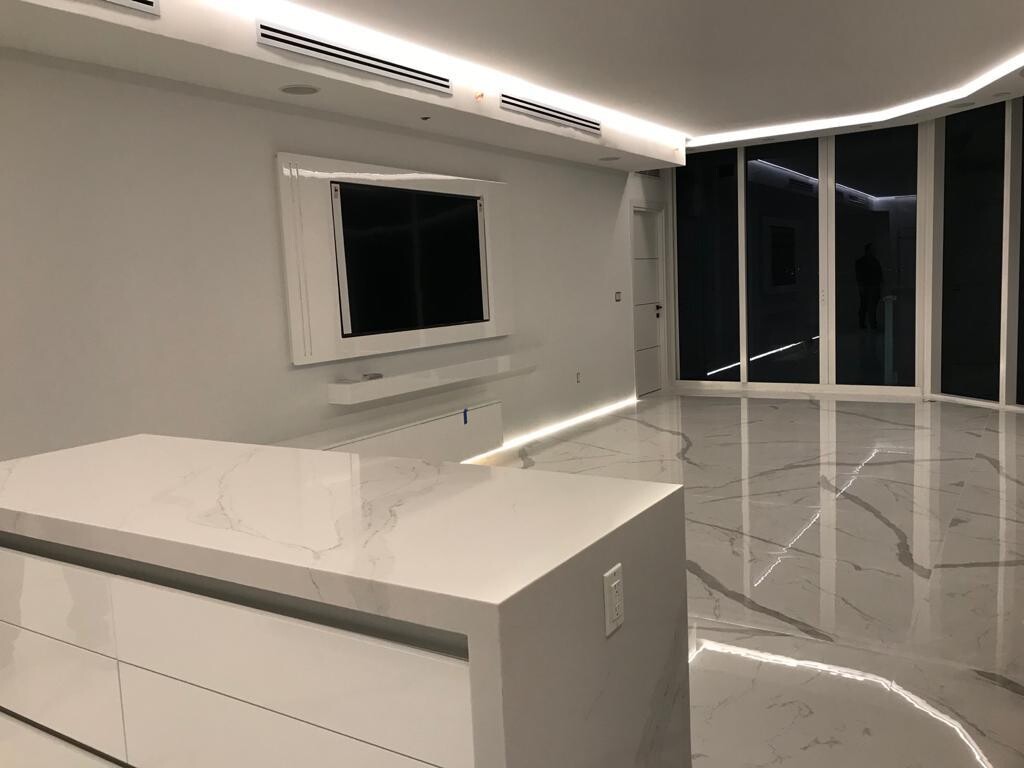 Floating media wall and kitchen island at night