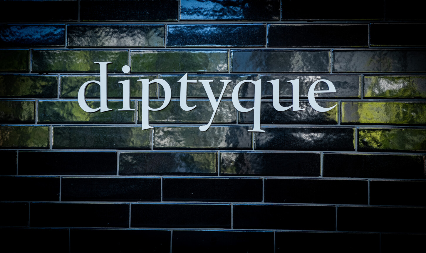 Diptyque wordmark signage set into a custom glazed tile wall, Diptyque Paris boutique
