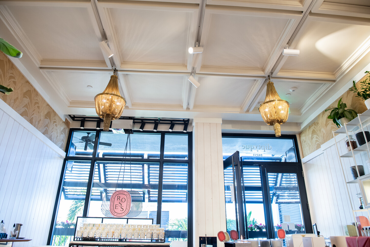 Interior view of custom millwork and coffered ceiling in a Diptyque Paris boutique retail fit-out