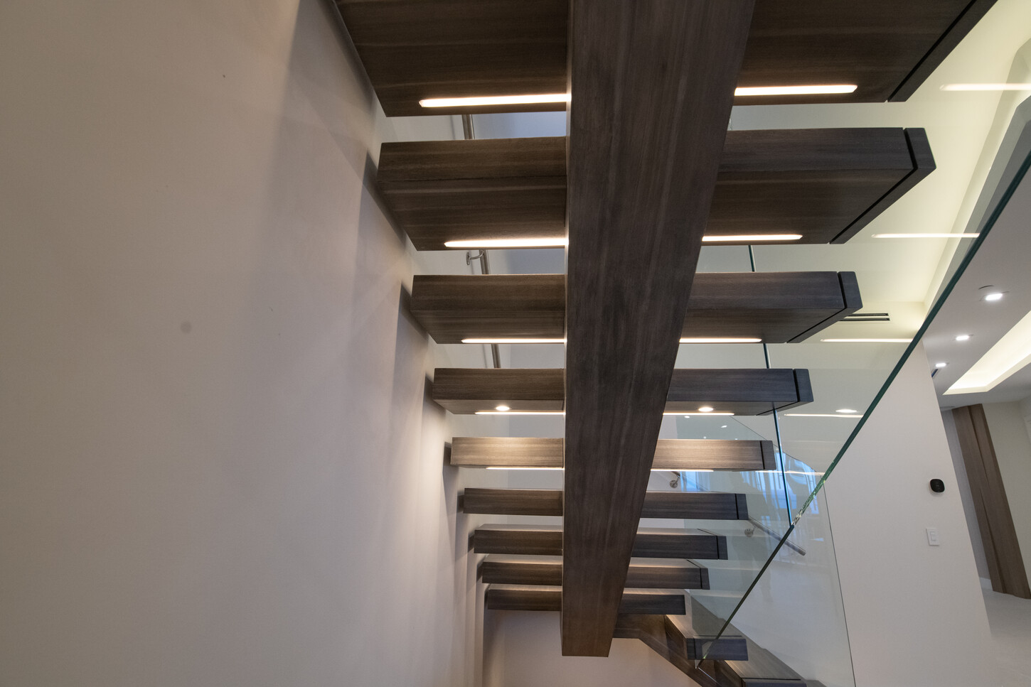 Full view of custom floating metal and glass staircase, Paramount Fort Lauderdale penthouse