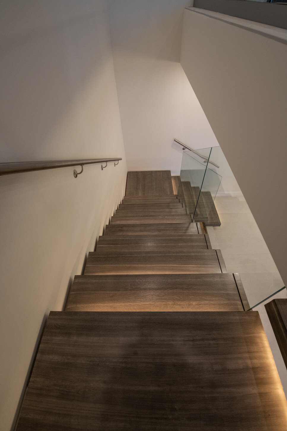 Solid white oak stair treads with warm light brown-grey stain