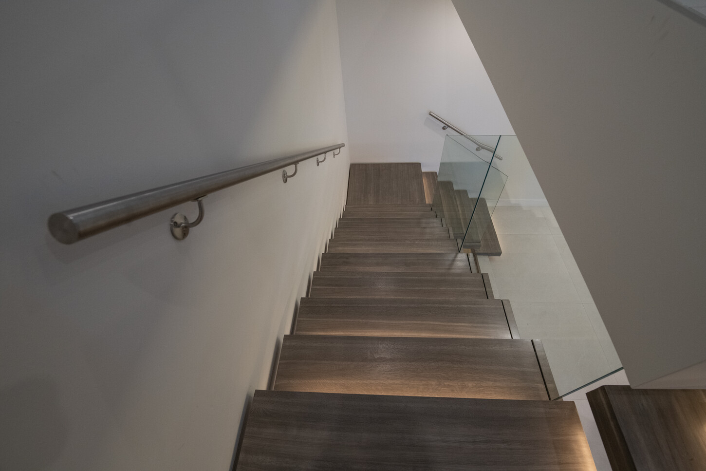 Solid white oak treads on a custom floating metal staircase