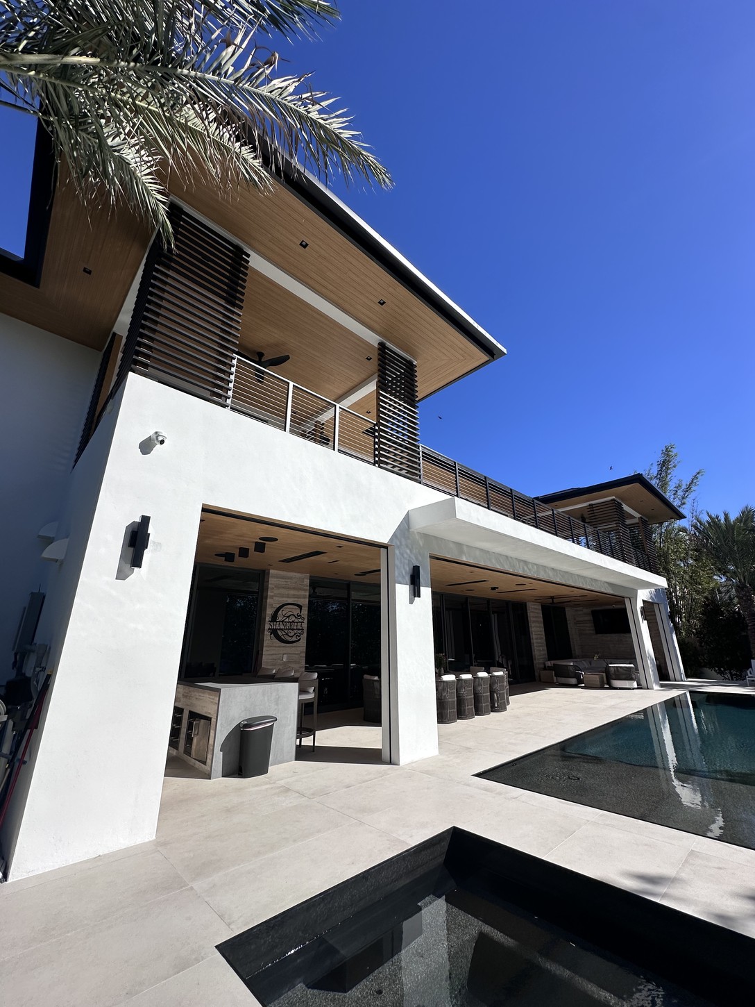 Second-story balcony and pool deck at a Coral Gables luxury residence