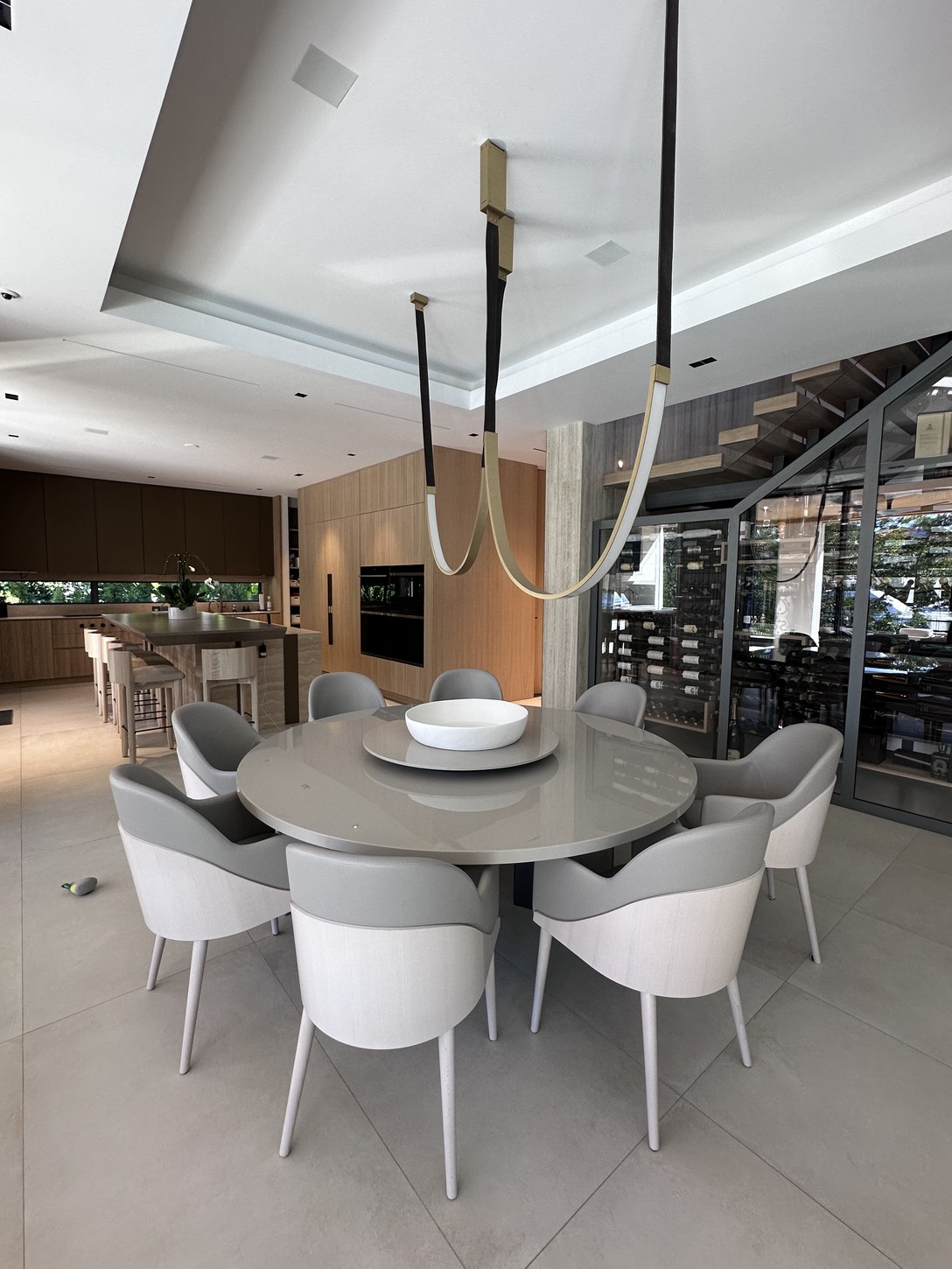 Kitchen island and dining area with custom millwork in a Coral Gables home