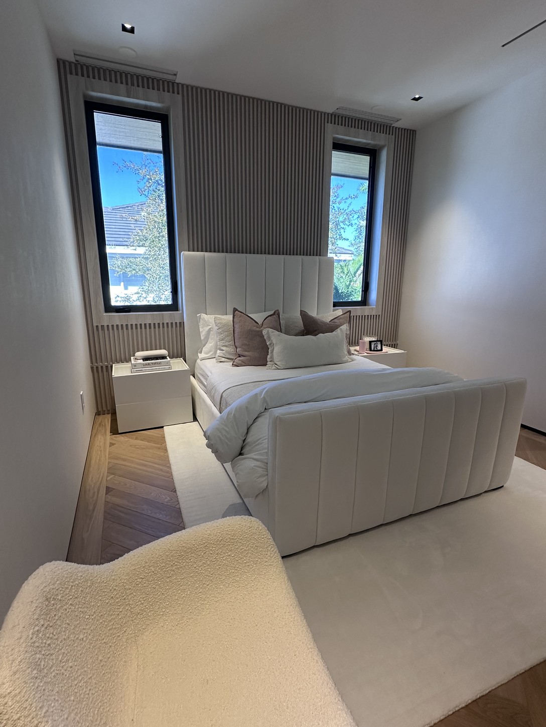 Wood-paneled accent wall in a Coral Gables primary bedroom suite