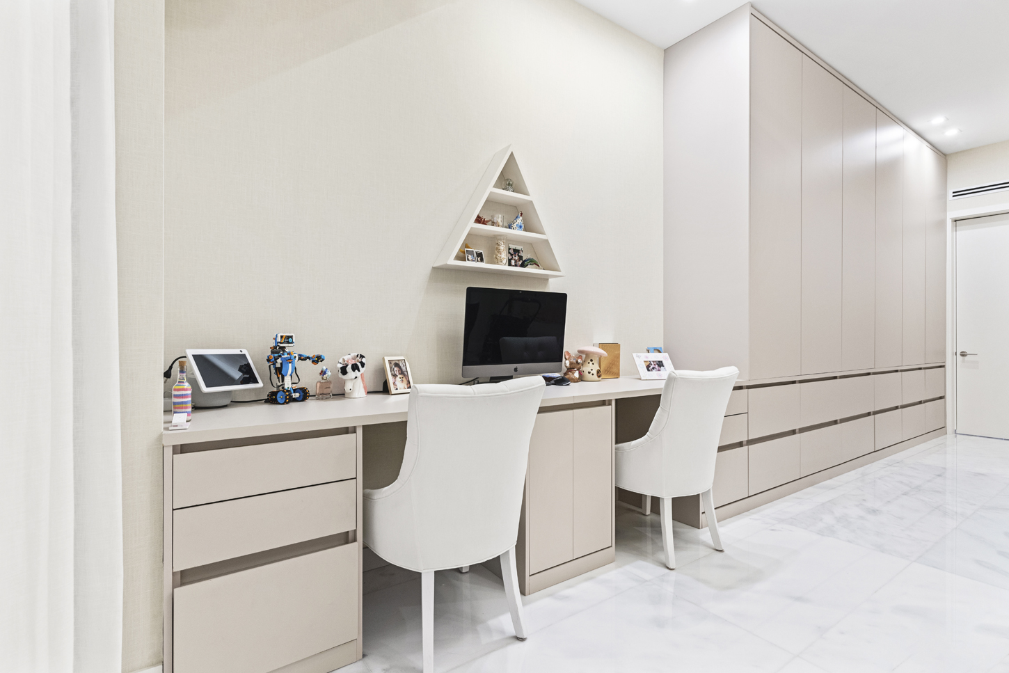 Custom built-in home office cabinetry and desk with matching paneled wall