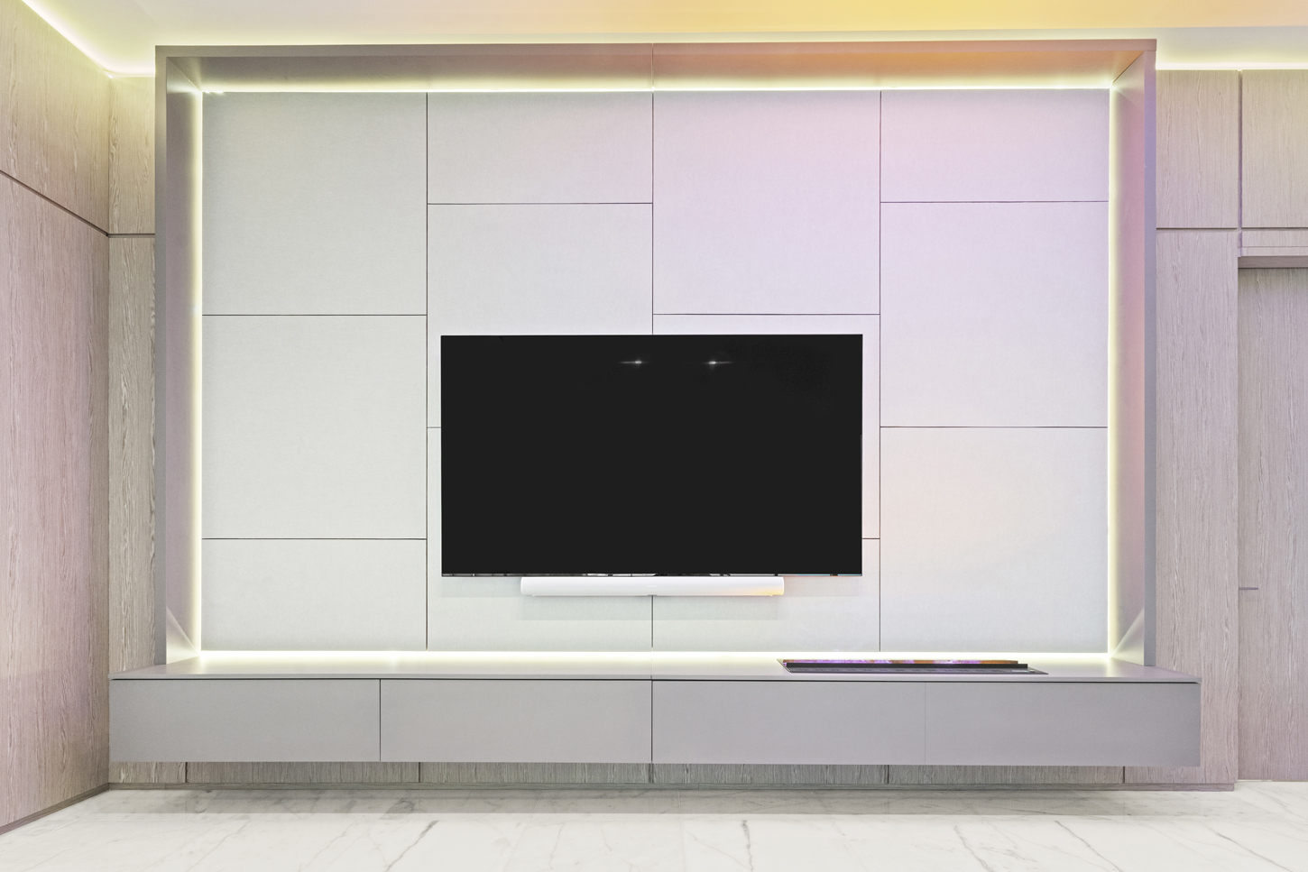 Custom architectural media wall with integrated lighting and paneled cabinetry