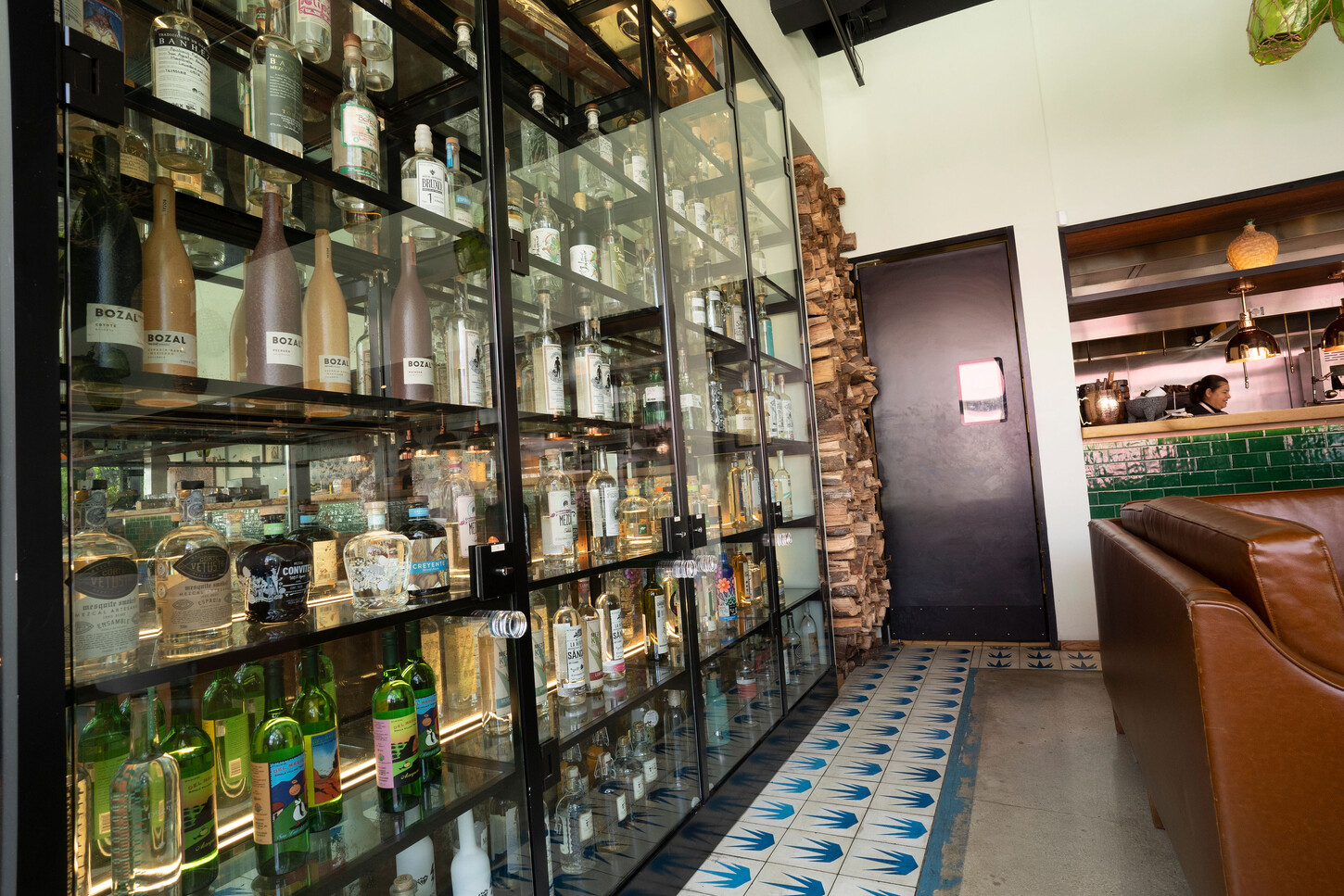 Custom black steel and glass liquor display cabinet at Bakan Wynwood in Miami