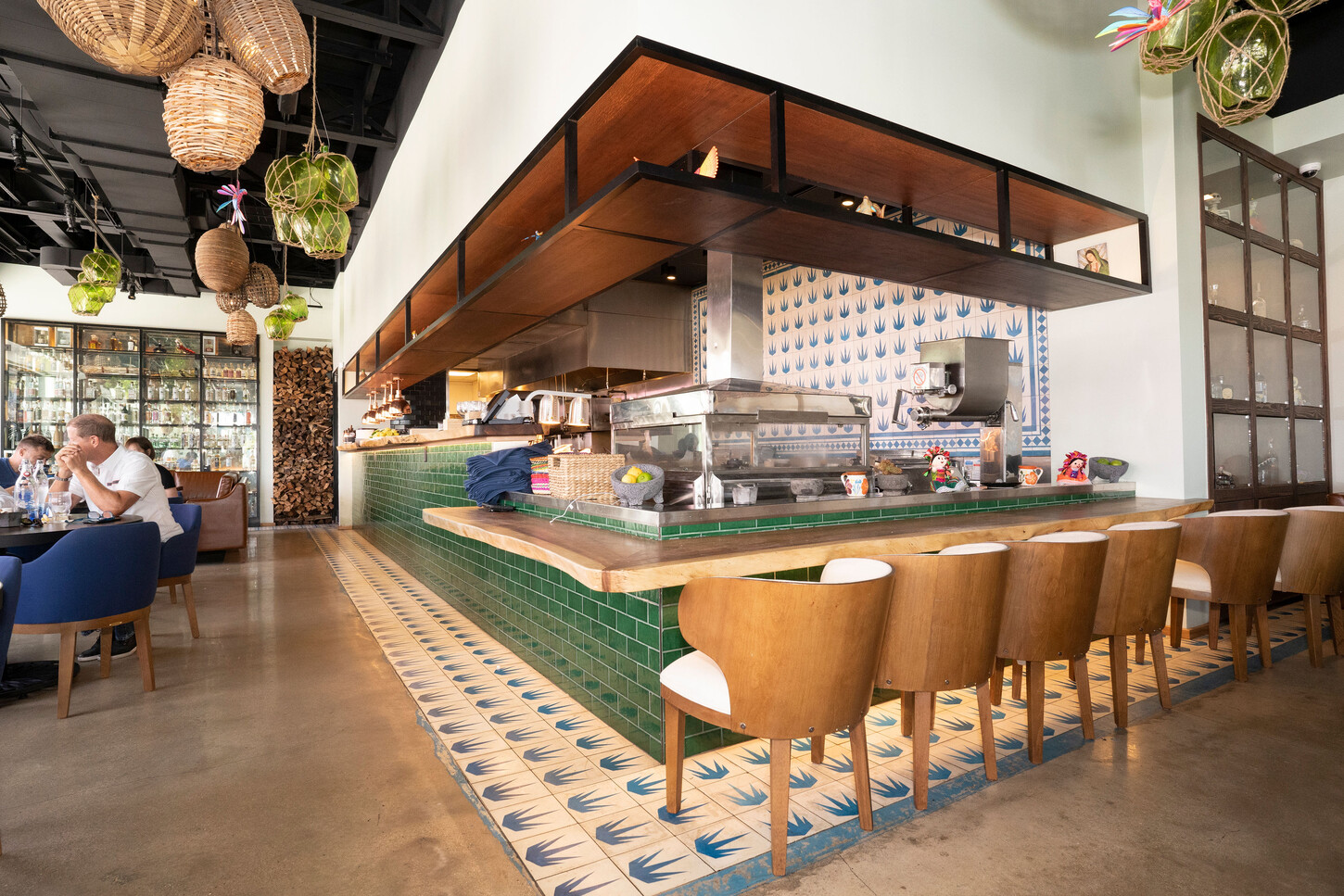 Wide view of the dining room and custom millwork counter at Bakan Wynwood in Miami