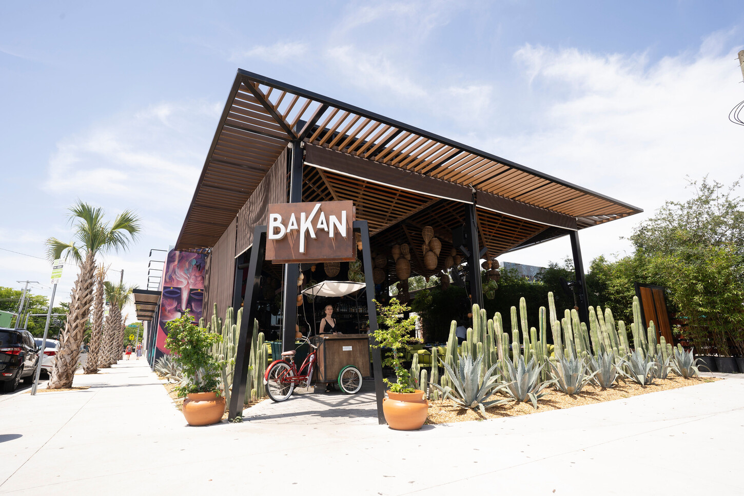 Wood slat roof on a black steel structure over the covered terrace at Bakan Wynwood in Miami