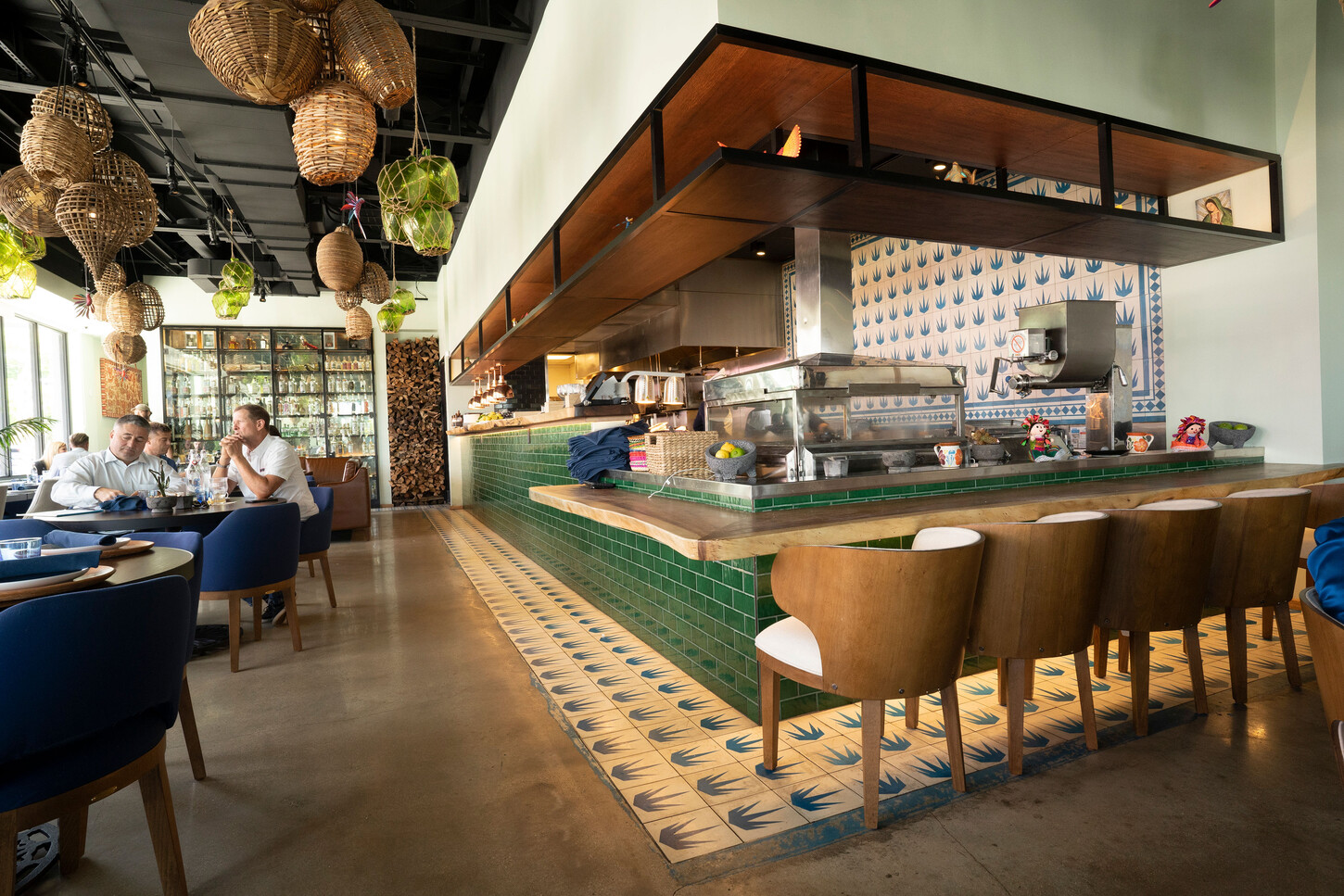 Open kitchen counter with green tile and a patterned ceramic floor at Bakan Wynwood in Miami