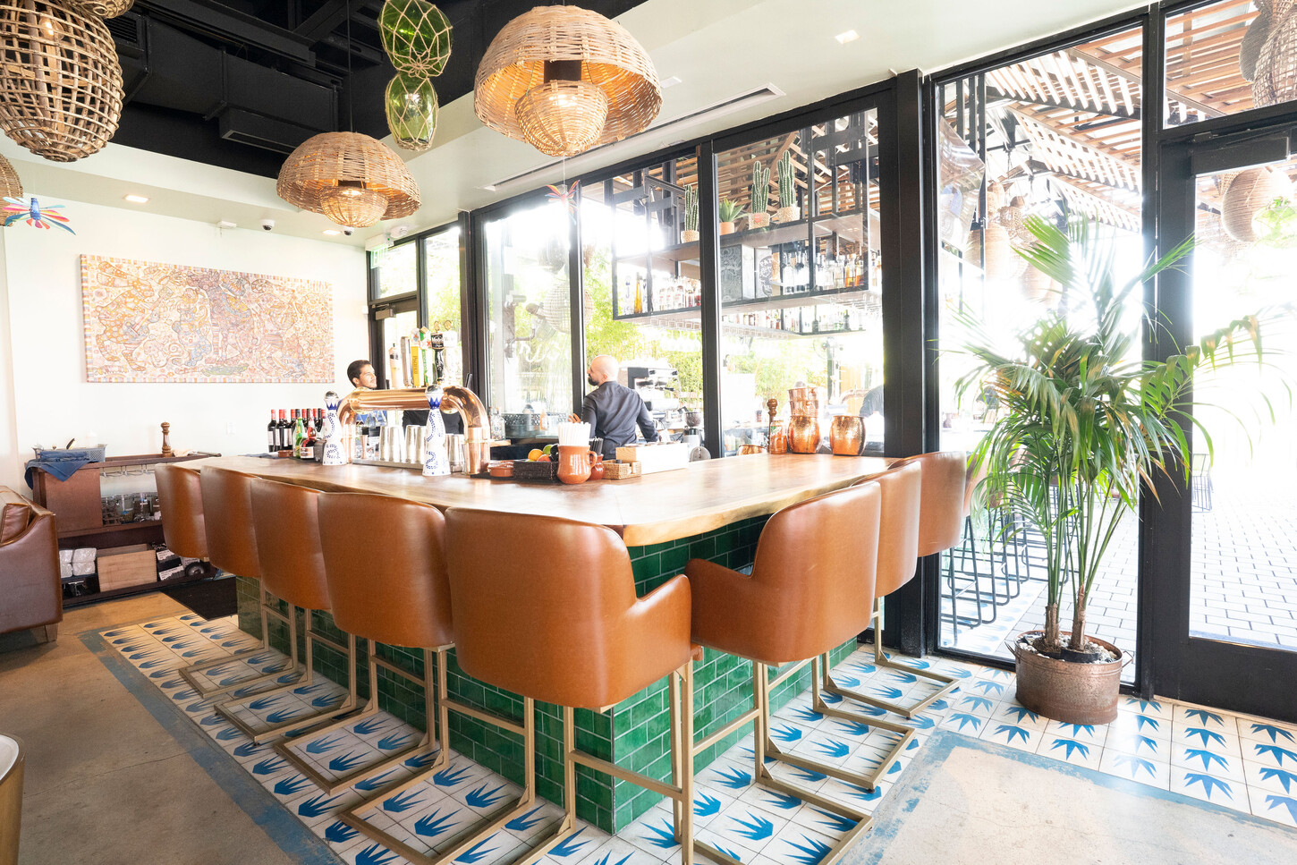 Wynwood bar with emerald tile, a wood top and patterned floor tile at Bakan in Miami