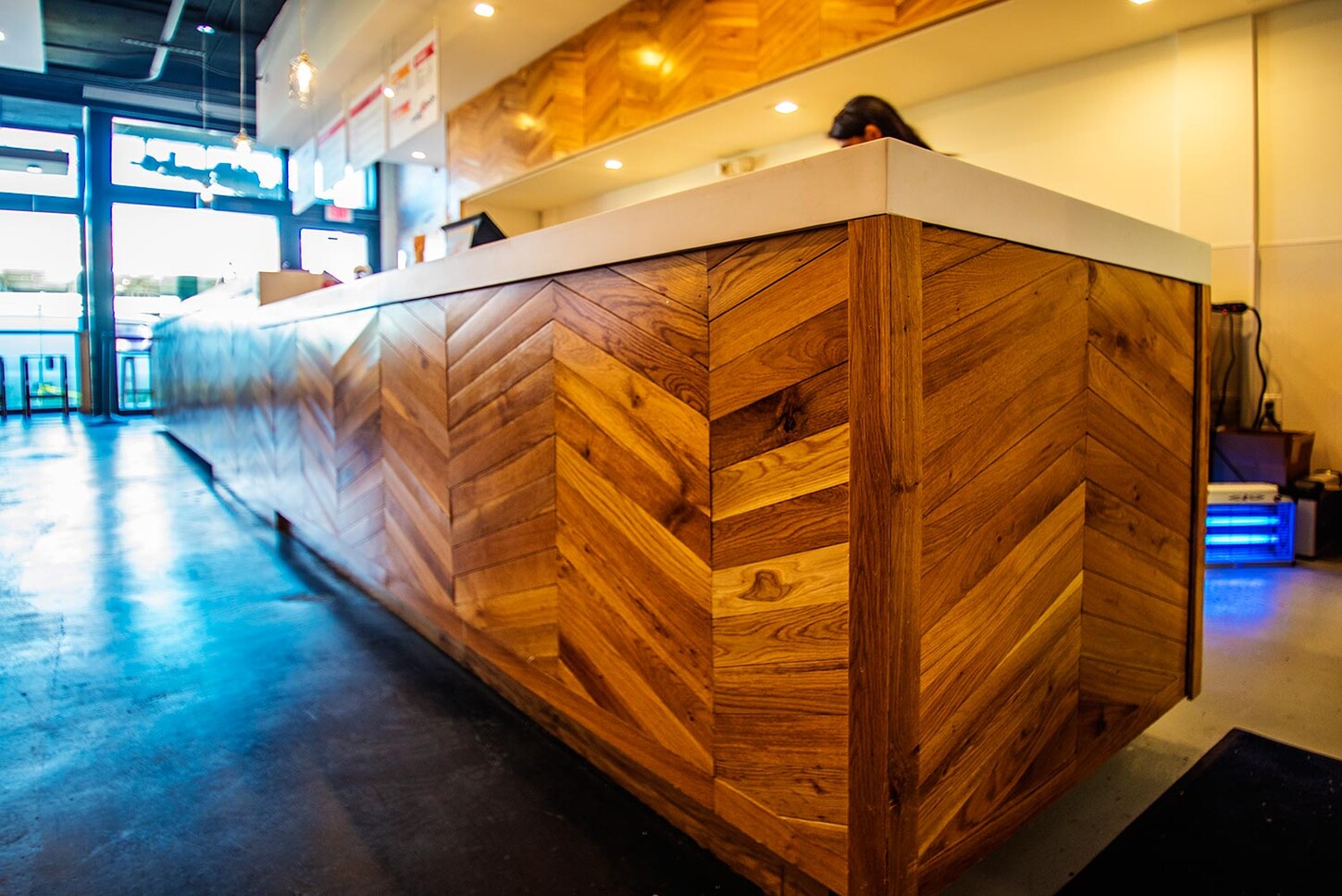 Corner of a custom chevron wood restaurant counter in Wynwood, Miami