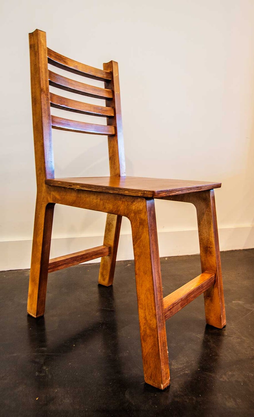 Custom ladder-back wood restaurant chair, angled view, built for a Miami restaurant
