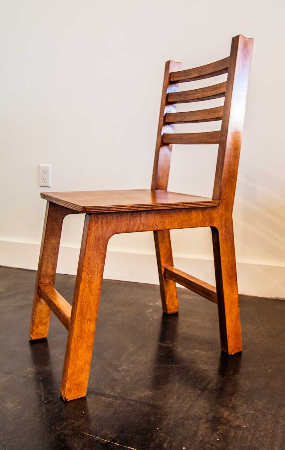 Custom ladder-back wood restaurant chair, side view, built for a Miami restaurant