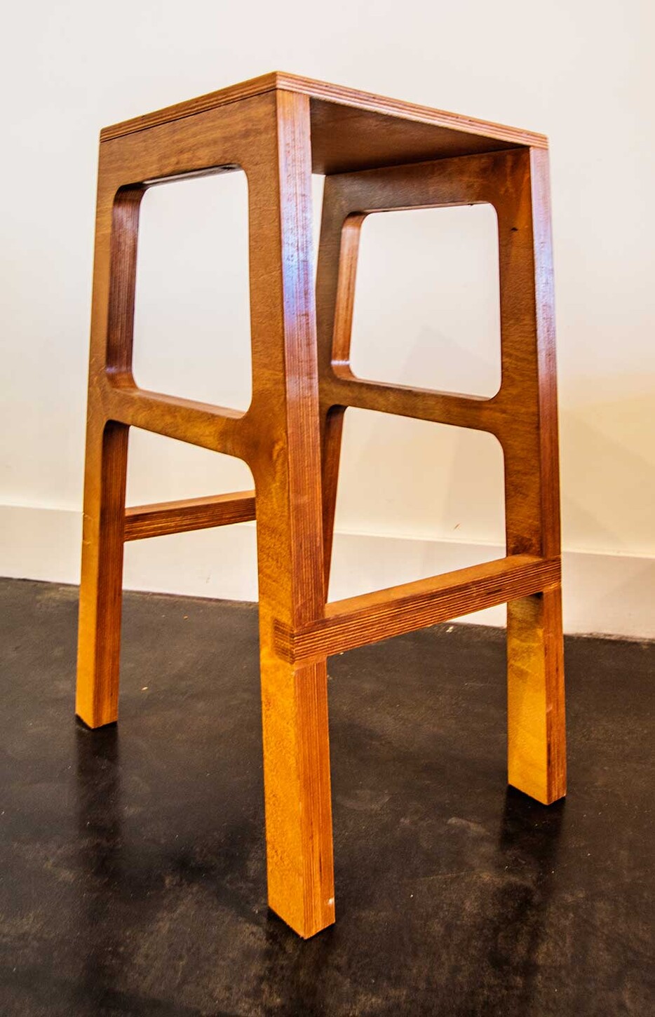 Custom open-frame wood bar stool, angled view, for a Miami restaurant
