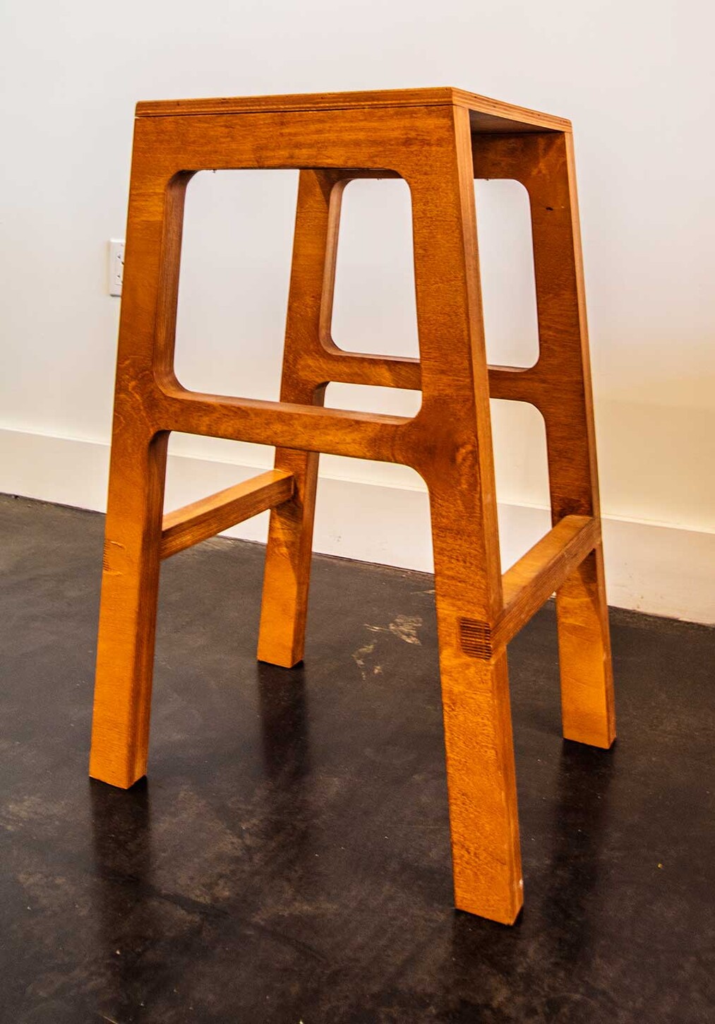 Custom open-frame wood bar stool, front view, for a Miami restaurant