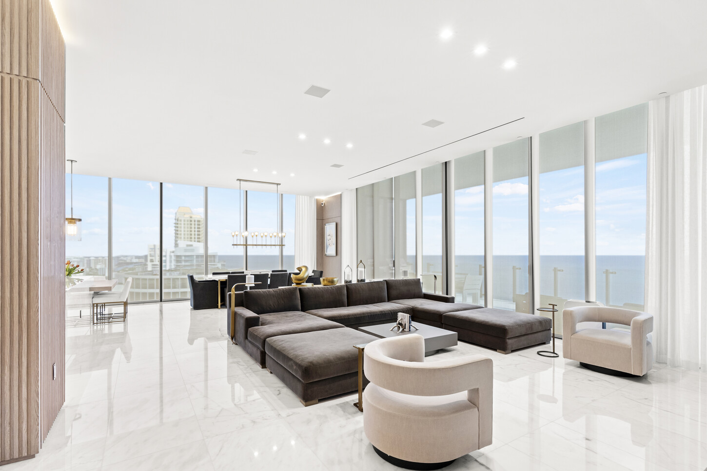 Living room with custom wall paneling and ocean views in the Muze Building, Sunny Isles, FL.