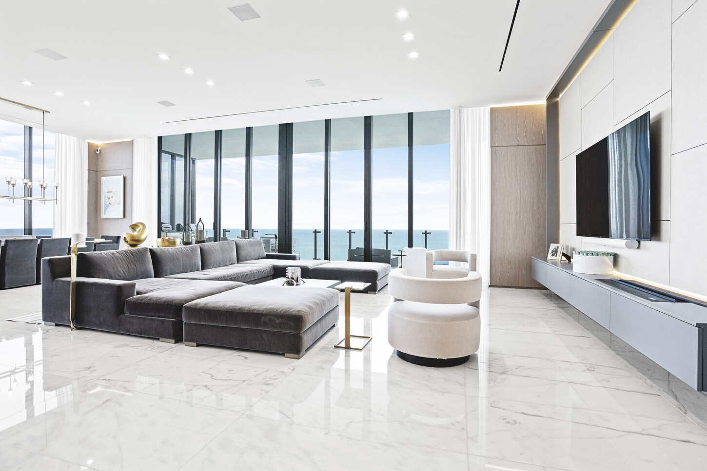 Living room wide view with custom wall paneling and TV feature wall, Sunny Isles, Miami.