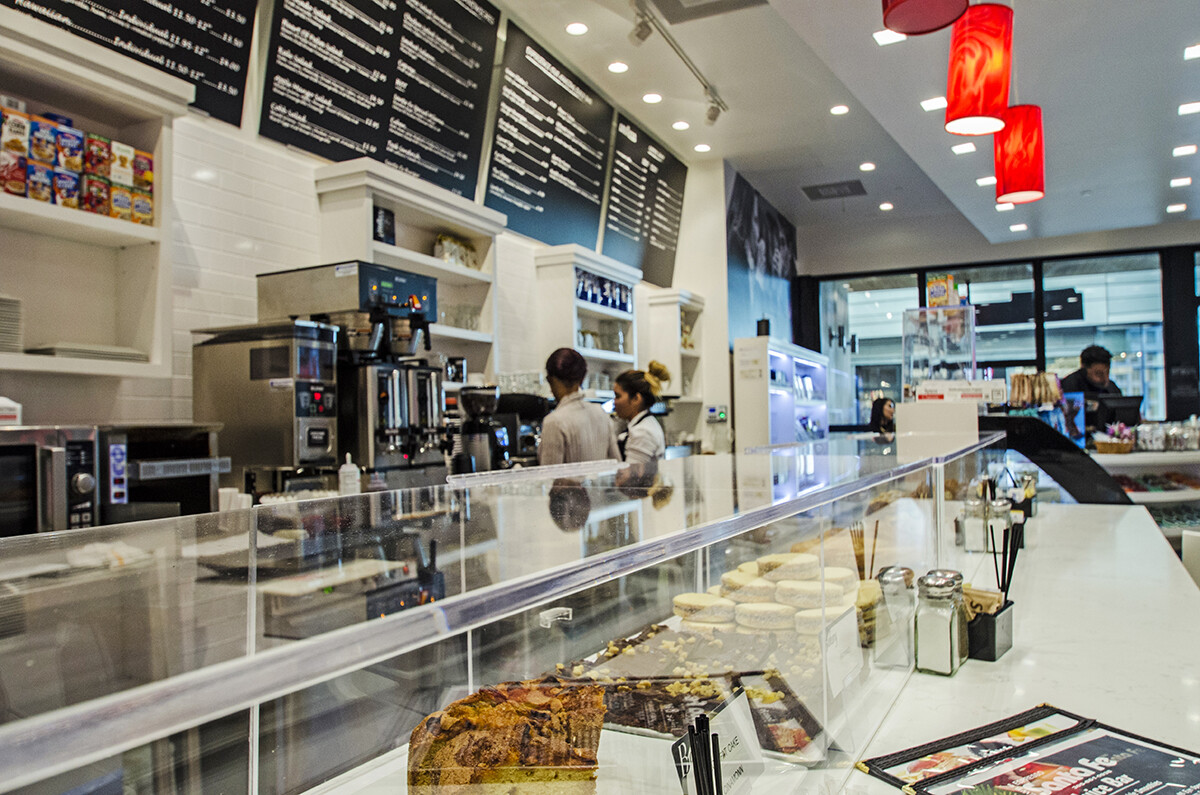 Coffee brewing station and pastry counter with a white countertop in a Brickell coffee shop, Miami