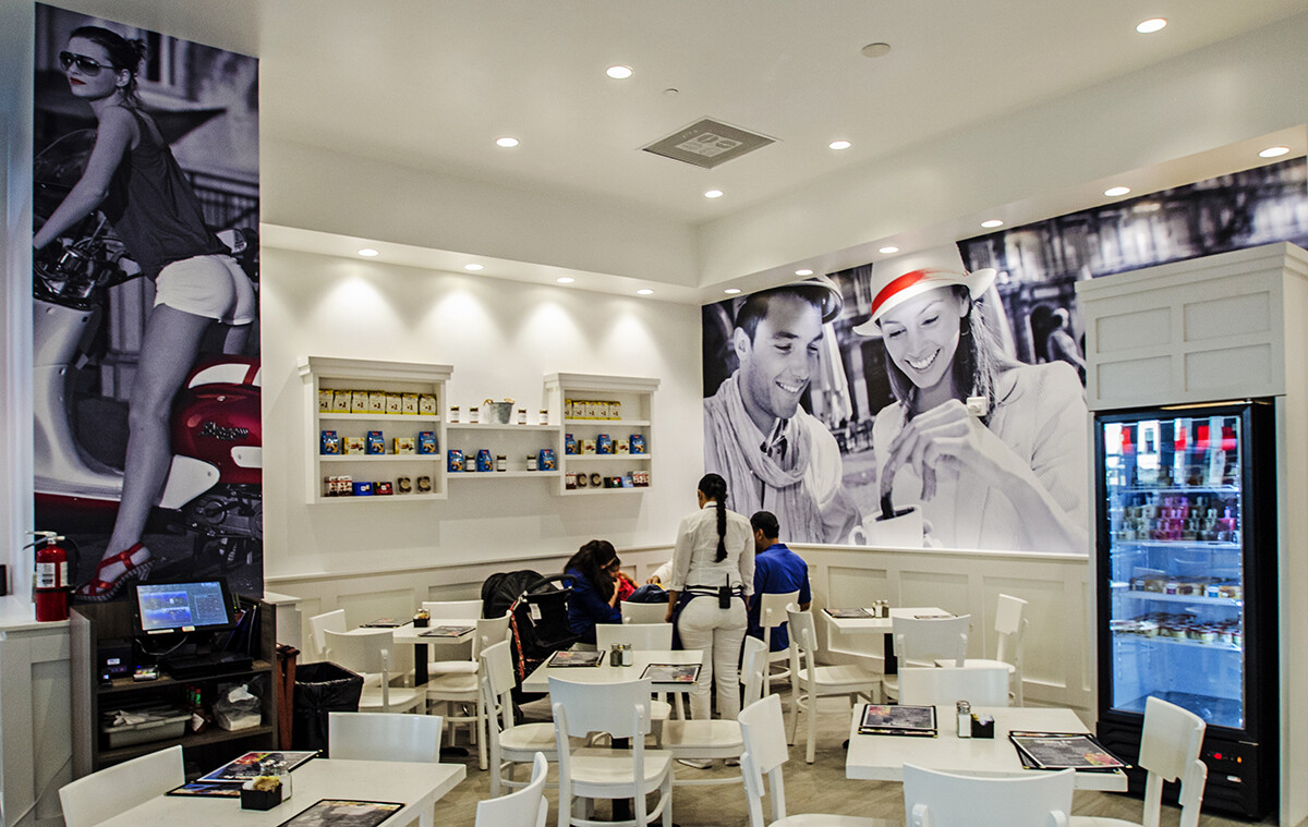 Custom molding and paneling beside a photo mural wall and seating in a Brickell coffee shop, Miami