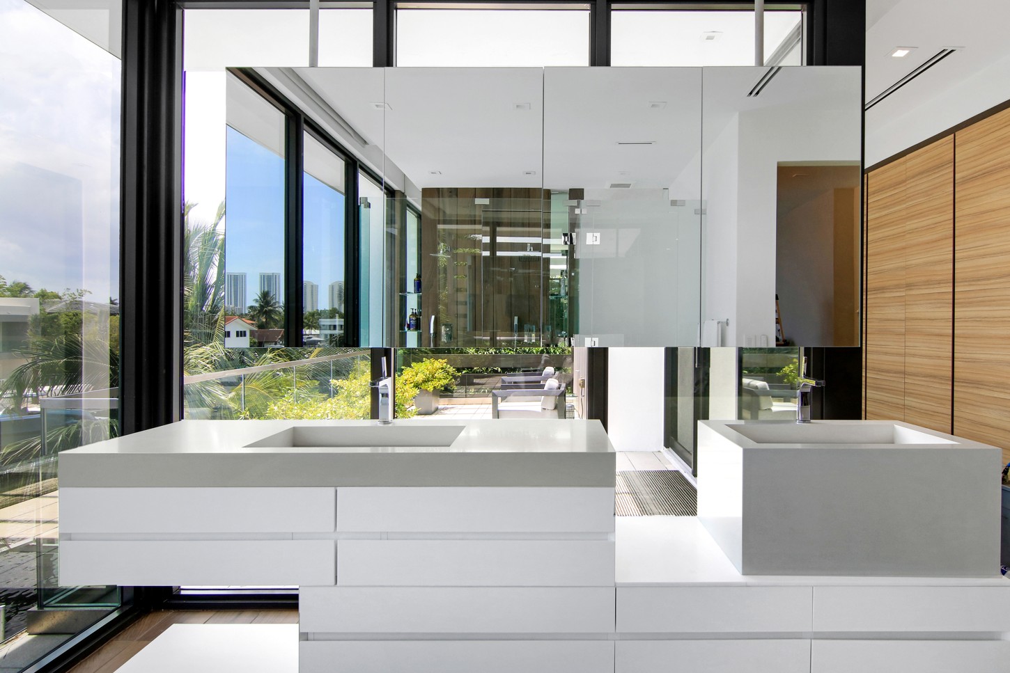 Custom floating vanity with stone sinks and glass shower, North Miami