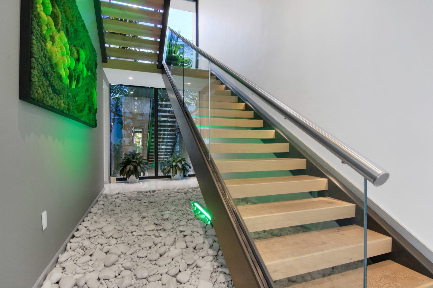 Floating staircase with stainless handrail, glass and LED lighting in North Miami